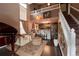 Inviting living room boasts soaring ceilings, a piano, open kitchen, and an elegant staircase at 12242 Bannock Cir # D, Denver, CO 80234