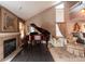 Elegant living room featuring a fireplace, baby grand piano, and high ceilings with large windows at 12242 Bannock Cir # D, Denver, CO 80234