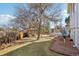 A large tree graces the backyard, next to the gazebo and hot tub at 8280 Everett Way, Arvada, CO 80005