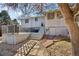Backyard view with patio, deck, and mature trees offering shade at 8280 Everett Way, Arvada, CO 80005