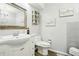 Well-lit bathroom with vanity, framed mirror, and contemporary fixtures at 8280 Everett Way, Arvada, CO 80005