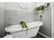 Bathroom features claw foot tub with modern tile and decor at 8280 Everett Way, Arvada, CO 80005
