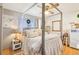 Bedroom with a four poster bed, wood floors, and white shiplap accent wall at 8280 Everett Way, Arvada, CO 80005