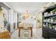 Bright dining room features farmhouse table, stylish decor, and adjacent kitchen view at 8280 Everett Way, Arvada, CO 80005