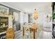 Bright dining room featuring a farmhouse table, decorative lighting, and neutral accents at 8280 Everett Way, Arvada, CO 80005