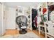 Unique dressing room featuring statement chair, vanity area, and organized clothing racks at 8280 Everett Way, Arvada, CO 80005