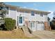 Charming exterior view of a multi-level home, featuring a welcoming entrance and attached garage at 8280 Everett Way, Arvada, CO 80005