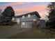 Two-story home with a two-car garage and mature trees in the yard at 8280 Everett Way, Arvada, CO 80005