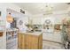 Stylish kitchen with a center island, white cabinets, and a view to the dining area at 8280 Everett Way, Arvada, CO 80005