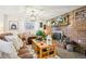 Warm living room showcasing brick fireplace, layered textiles, and inviting atmosphere at 8280 Everett Way, Arvada, CO 80005