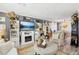 Inviting living room with fireplace, decorative shelving, and open dining area at 8280 Everett Way, Arvada, CO 80005