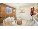 Charming living room with a decorative brick wall and white wainscoting at 8280 Everett Way, Arvada, CO 80005