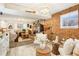 Bright living room showcasing a brick accent wall, entertainment area, and comfortable seating at 8280 Everett Way, Arvada, CO 80005
