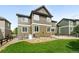 Backyard view featuring a patio, well-kept lawn, and multi story home at 11985 Singing Winds St, Parker, CO 80138