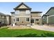 Backyard view featuring a patio, well-kept lawn, and multi story home at 11985 Singing Winds St, Parker, CO 80138