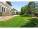 View of lush green backyard with healthy lawn and fence at 11985 Singing Winds St, Parker, CO 80138