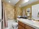 Cozy bathroom with a shower over the bath and modern sink atop wooden cabinets at 11985 Singing Winds St, Parker, CO 80138