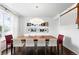 Elegant dining room with large table, modern light fixture, and stylish decor at 11985 Singing Winds St, Parker, CO 80138