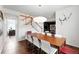 Bright dining room with wood floors, a large table with white chairs, and unique lighting fixture at 11985 Singing Winds St, Parker, CO 80138
