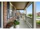 Cozy front porch features brick accents, outdoor seating, and charming decor at 11985 Singing Winds St, Parker, CO 80138