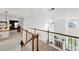 Bright hallway with wood railing overlooking the living room and fireplace below at 11985 Singing Winds St, Parker, CO 80138
