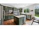 Stylish kitchen with stainless steel appliances, green cabinets, and a center island with cooktop at 11985 Singing Winds St, Parker, CO 80138