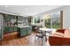 Eat-in kitchen boasts designer green cabinetry, stainless steel appliances and ample countertop space at 11985 Singing Winds St, Parker, CO 80138
