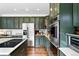 Kitchen features stainless steel appliances, granite countertops, and custom cabinets at 11985 Singing Winds St, Parker, CO 80138