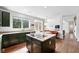 Open concept kitchen featuring stainless steel appliances, green cabinets, and a view to the patio at 11985 Singing Winds St, Parker, CO 80138