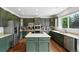 Bright kitchen featuring stainless steel appliances, a center island, and ample counter space at 11985 Singing Winds St, Parker, CO 80138