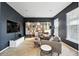 Cozy living room with gray paint, built-in shelving, comfortable seating, and lots of books at 11985 Singing Winds St, Parker, CO 80138
