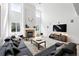 Inviting living room with natural light, comfortable seating, and a decorative fireplace at 11985 Singing Winds St, Parker, CO 80138