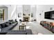 Bright and airy living room with tall windows, fireplace, and modern decor at 11985 Singing Winds St, Parker, CO 80138