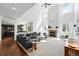 Open-concept living room with a fireplace, high ceilings, and seamless flow to the kitchen at 11985 Singing Winds St, Parker, CO 80138