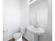 Bright, minimalist powder room with a white pedestal sink and wood-look flooring at , Aurora, CO 80019