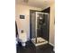 Modern bathroom with a glass enclosed shower and dark tile flooring at 475 W 12Th Ave # 4E, Denver, CO 80204
