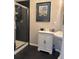 Stylish bathroom featuring a white vanity and a glass-enclosed shower with black tile accents at 475 W 12Th Ave # 4E, Denver, CO 80204