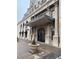 Elegant building entrance featuring ornate columns and ironwork, plus a landscaped planter at 475 W 12Th Ave # 4E, Denver, CO 80204