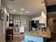 Bright kitchen featuring granite counters, white cabinetry, and modern stainless steel appliances at 475 W 12Th Ave # 4E, Denver, CO 80204