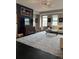 Bright living room with a patterned rug, dark floors, and large windows at 475 W 12Th Ave # 4E, Denver, CO 80204