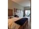 Comfortable bedroom with a balcony offering views of the city at 475 W 12Th Ave # 4E, Denver, CO 80204