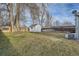 Generous backyard featuring a storage shed, mature trees, and plenty of green space at 5235 Dover St, Arvada, CO 80002