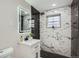 Modern bathroom features a sleek vanity and luxurious tiled shower at 5235 Dover St, Arvada, CO 80002