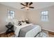 Cozy bedroom with a ceiling fan, hardwood floors, and geometric area rug at 5235 Dover St, Arvada, CO 80002
