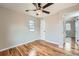 Cozy bedroom boasts wood floors, neutral walls, and view to the hallway with a white door at 5235 Dover St, Arvada, CO 80002