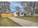Charming home featuring a well-maintained lawn, long driveway, and a quaint exterior at 5235 Dover St, Arvada, CO 80002