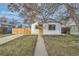Exterior view of a cozy home with a well-kept front lawn and inviting curb appeal at 5235 Dover St, Arvada, CO 80002