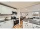 Updated kitchen with stainless steel appliances, gray countertops, and adjacent dining area at 5235 Dover St, Arvada, CO 80002