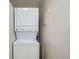 Laundry area featuring stacked washer and dryer in a compact space with neutral walls at 5235 Dover St, Arvada, CO 80002
