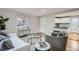 A living room with hardwood floors that opens to the kitchen at 5235 Dover St, Arvada, CO 80002